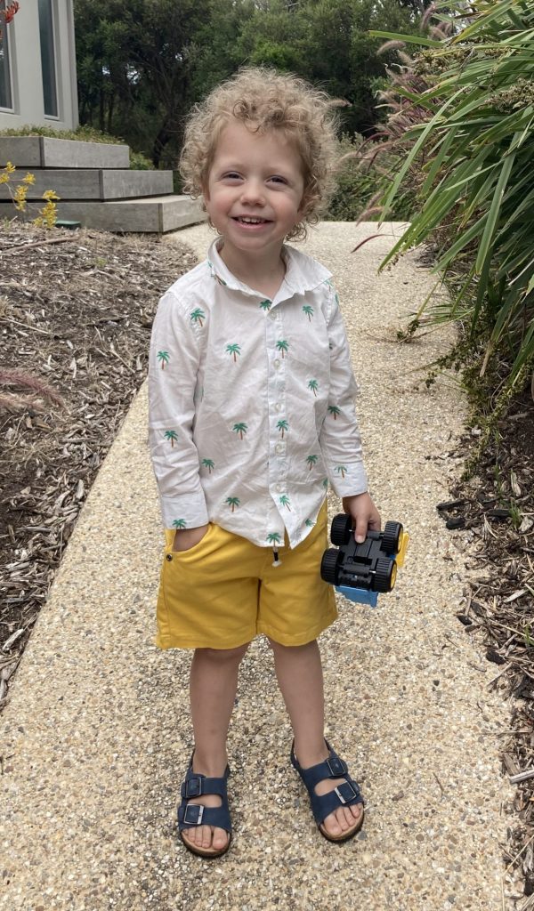 Lachy playing outside with his toy car