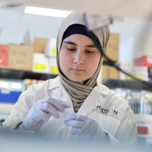 Raya cancer survivor in the lab at Hudson Institute