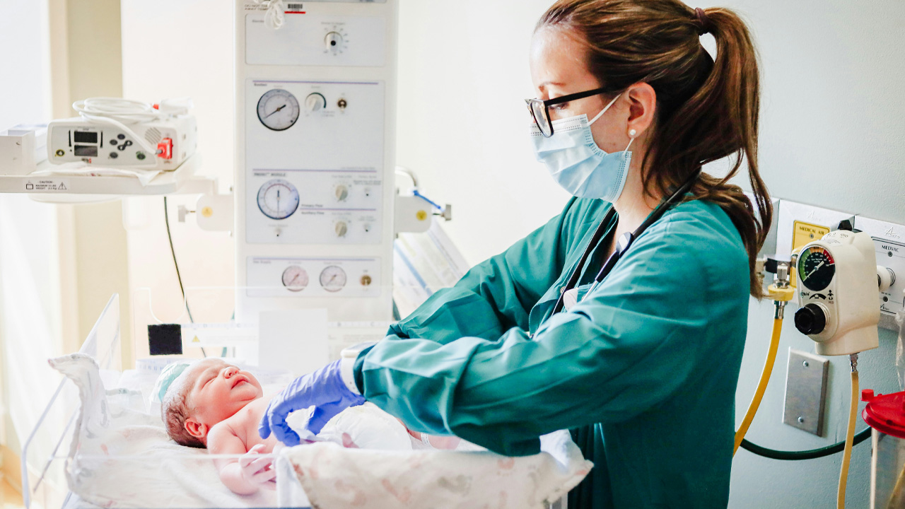 Baby and nurse in a surgical mask facial perception